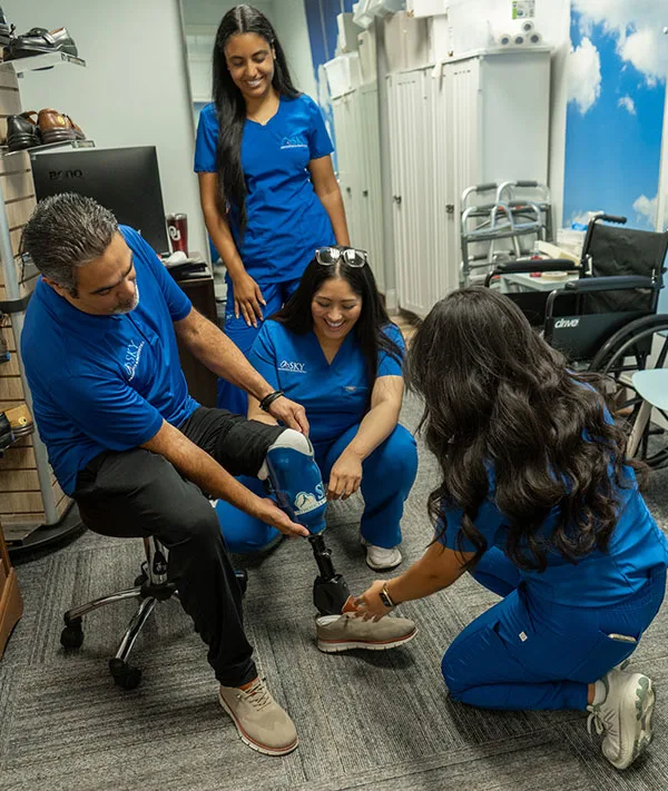 Patient with prosthetic leg being fitted by Sky O&P team